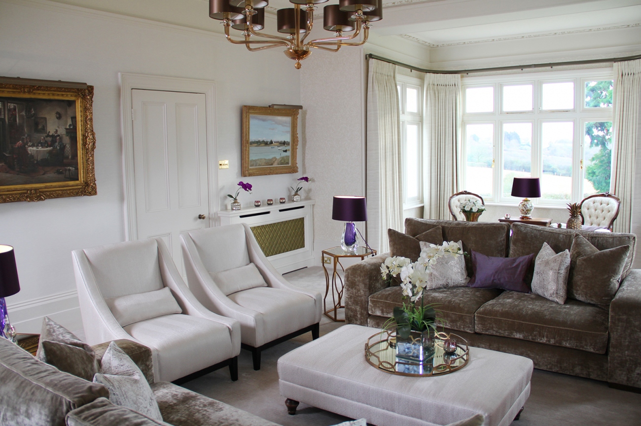 Date: May 2017 Location: Goffs Oak, Hertfordshire Rooms: Living Area
A modern family living space with traditional accents. Created from deep squashy sofas for maximum comfort and accented with contemporary metal accessories and side table. Purple adds richness and depth to an otherwise neutral palette.